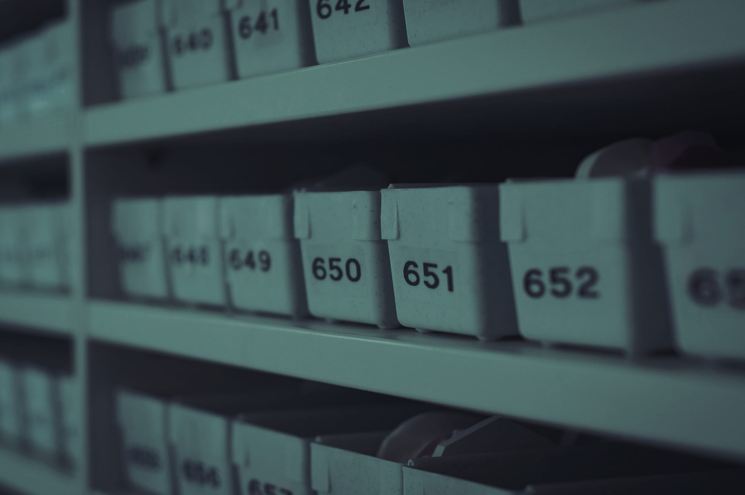 Numbered white storage bins on shelving.